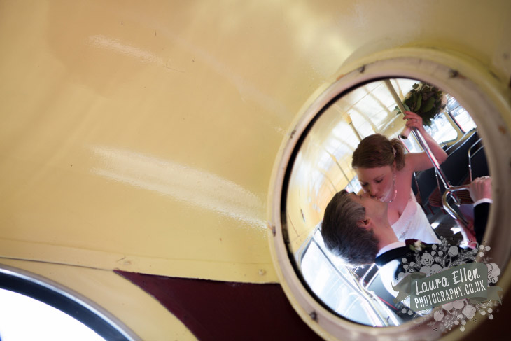 Bride and Groom kissing into Routemaster viewing mirror