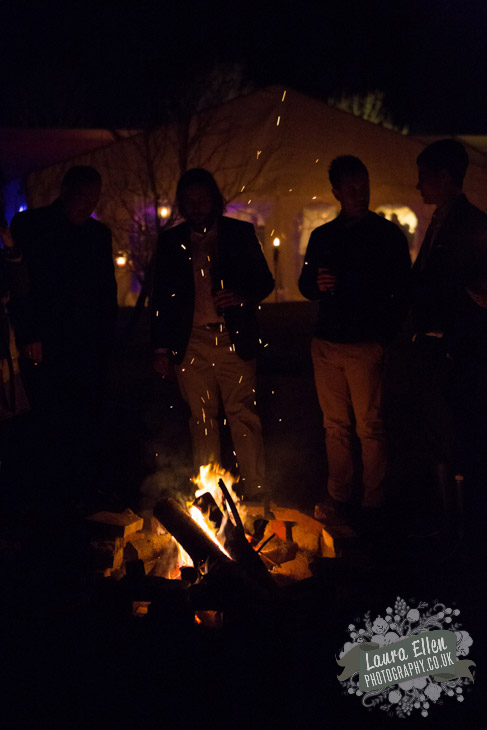 wedding guests around bonfire